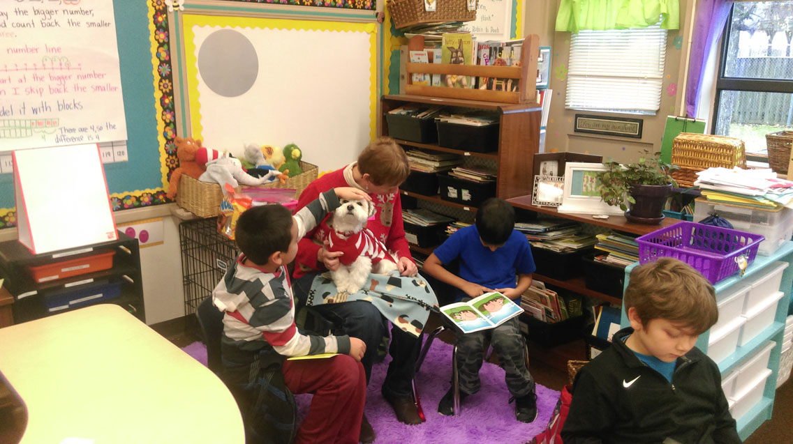A reading dog visits Sunrise Elementary School for storytime.
