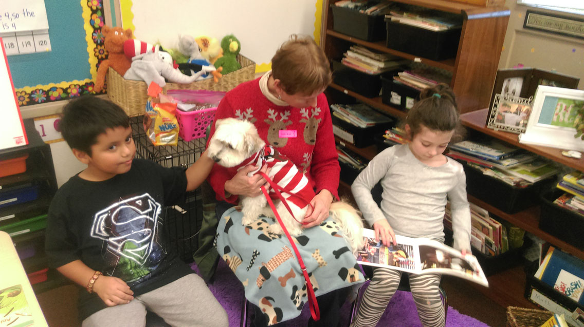 A reading dog visits Sunrise Elementary School for storytime.