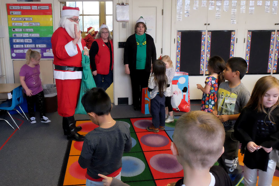 Santa Claus talks to students.