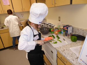 Child cutting peppers