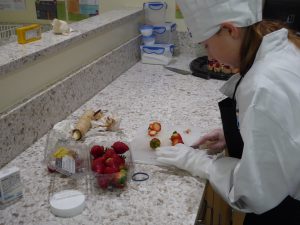 Child slicing strawberries