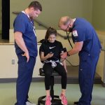 Child getting vitals taken by nurses