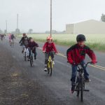 Kids riding bikes in the rain