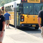 School buses drop staff off for rally