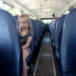 girl sitting on bus seat