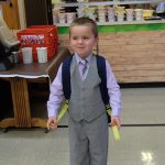 Kindergarten student in suit on first day of school