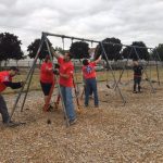 Volunteers fix the swingset