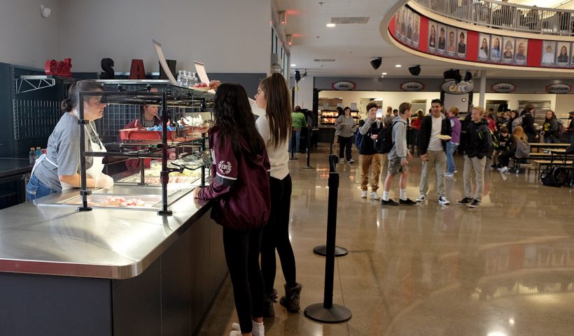 Students getting food at lunch counter