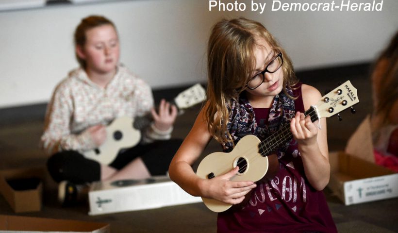Girls play ukulele during Genius Hour