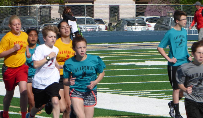 Students running at middle school track meet.